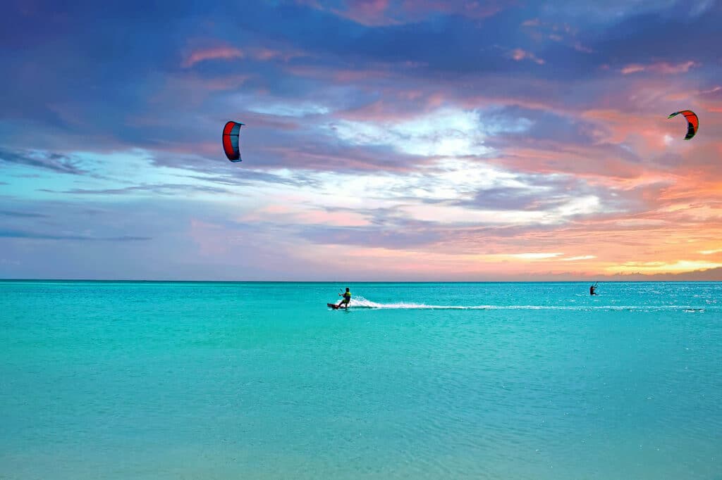 Kite surfing at Aruba island in the caribbean sea at sunset